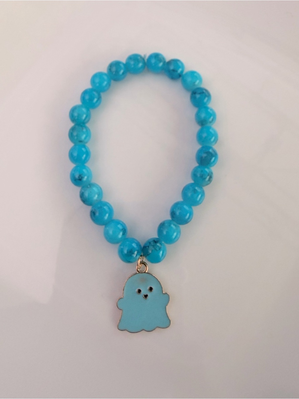 Blue Beaded Bracelet with Playful Ghost Charm
